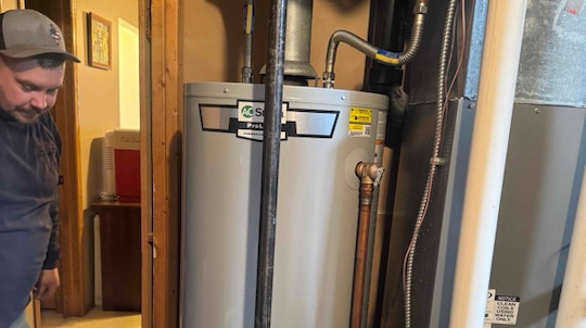 Technician working on water heater installation